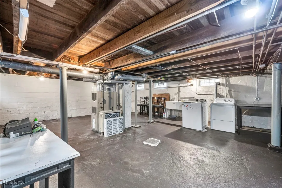 Basement featuring independent washer and dryer and a sink