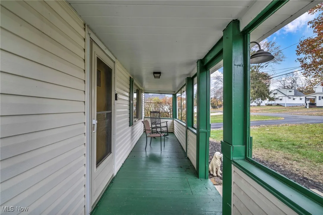 Unfurnished sunroom featuring covered porch and healthy amount of natural light