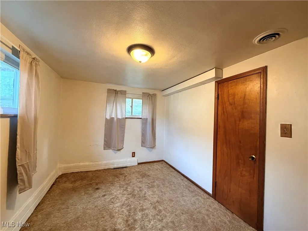 Carpeted bedroom featuring a closet