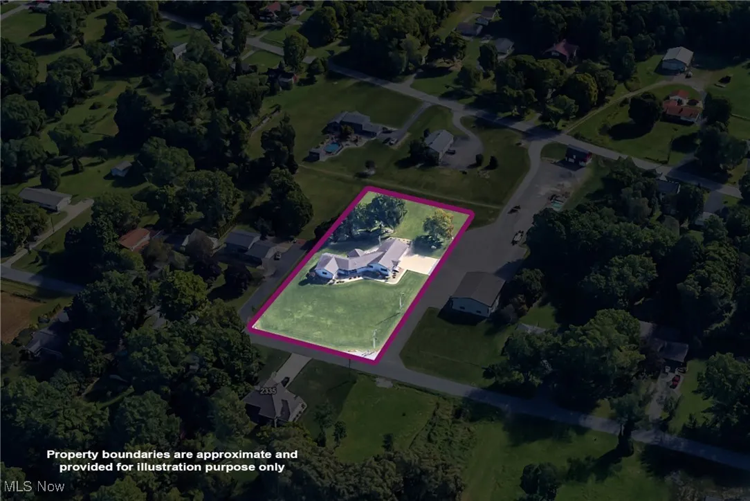 Aerial overview of property's location with property parcel outlined and a tree filled landscape
