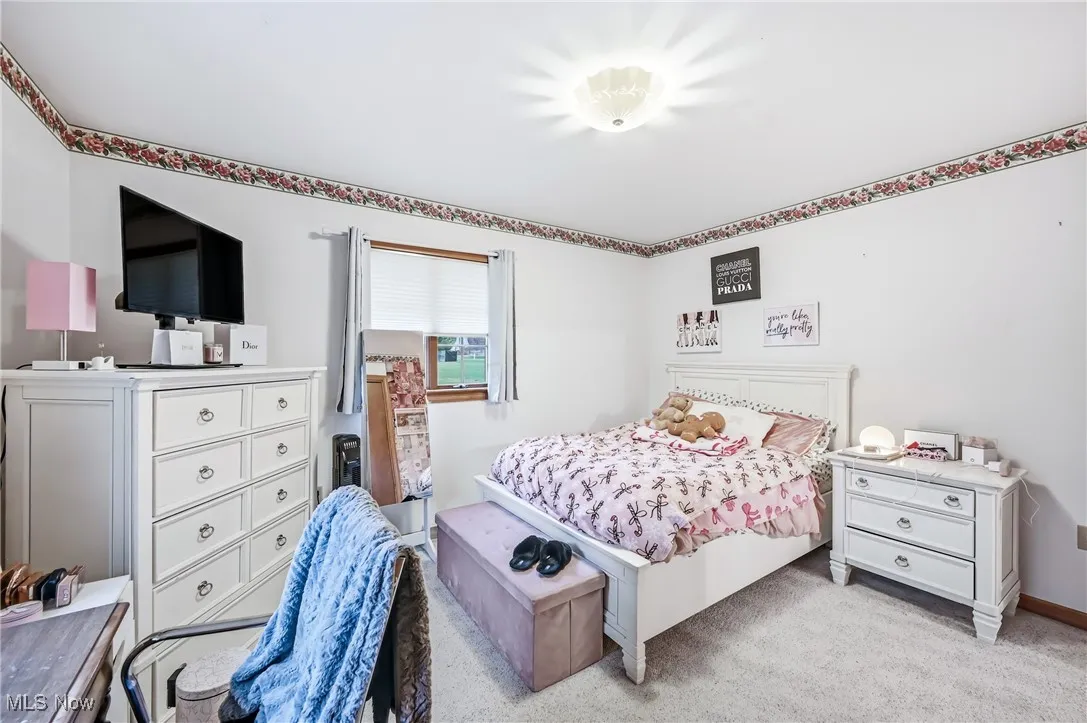 Bedroom featuring light colored carpet