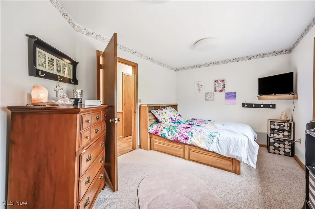 Bedroom with light colored carpet