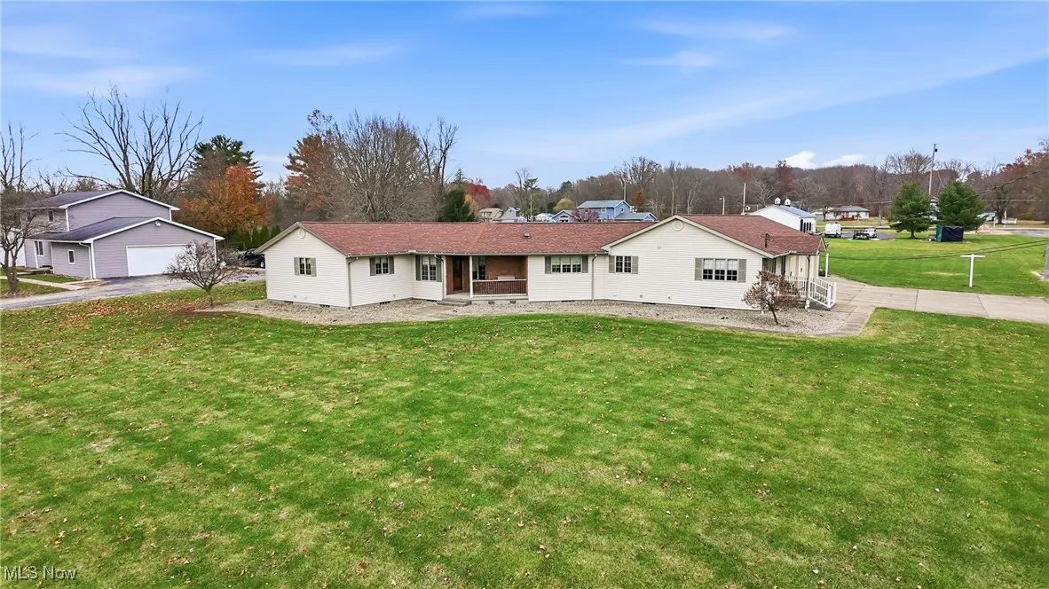View of front of property featuring a patio and a front lawn
