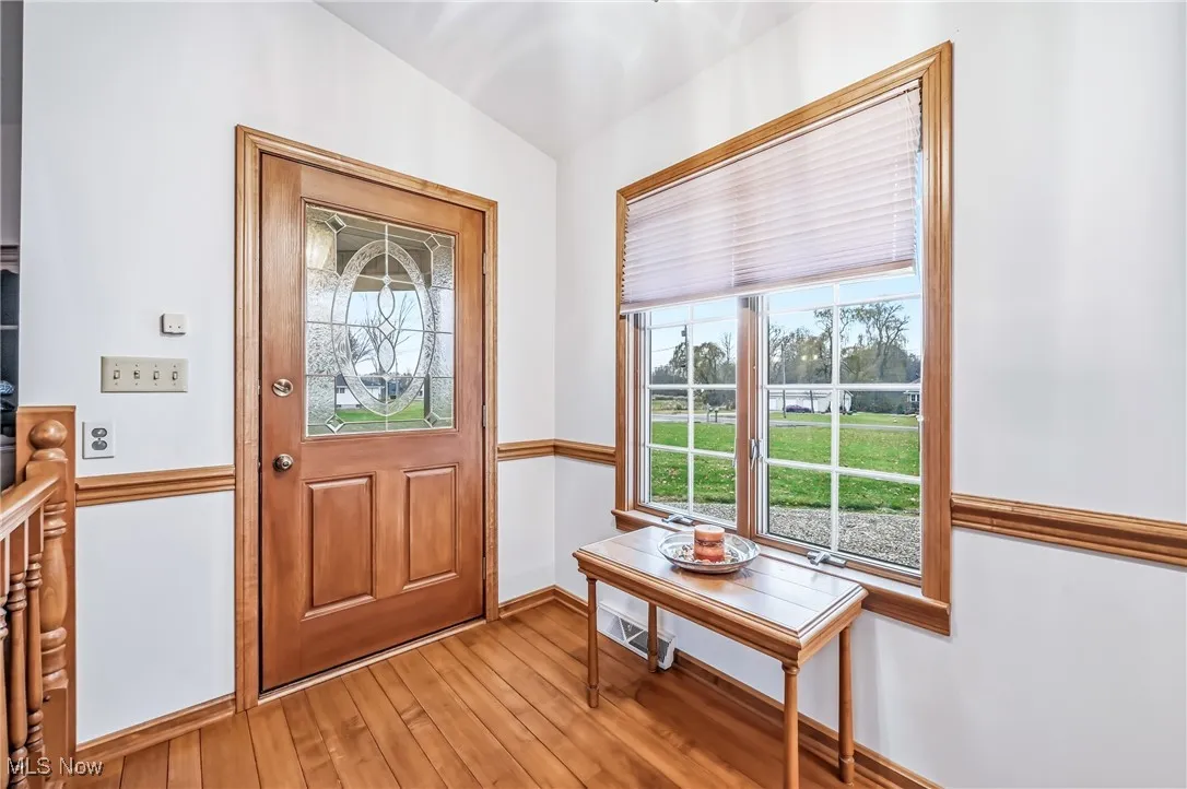 Entryway with light wood-type flooring and baseboards