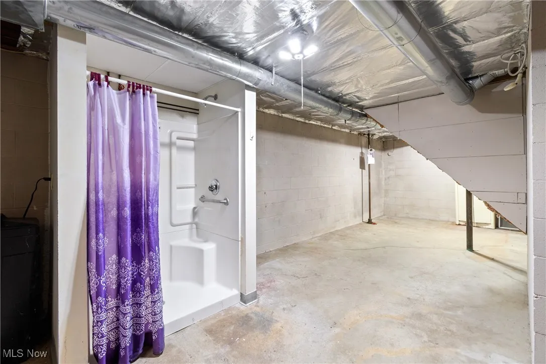 Step-in shower with seat in the lower level.