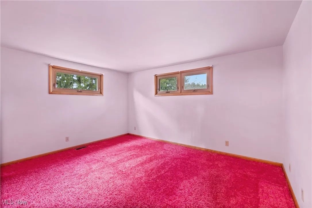 Bedroom has hardwood floors under carpeting.