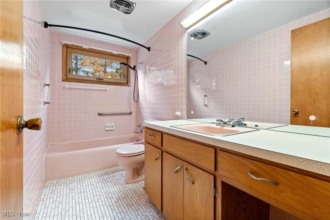 Full bath with tub/shower combination.