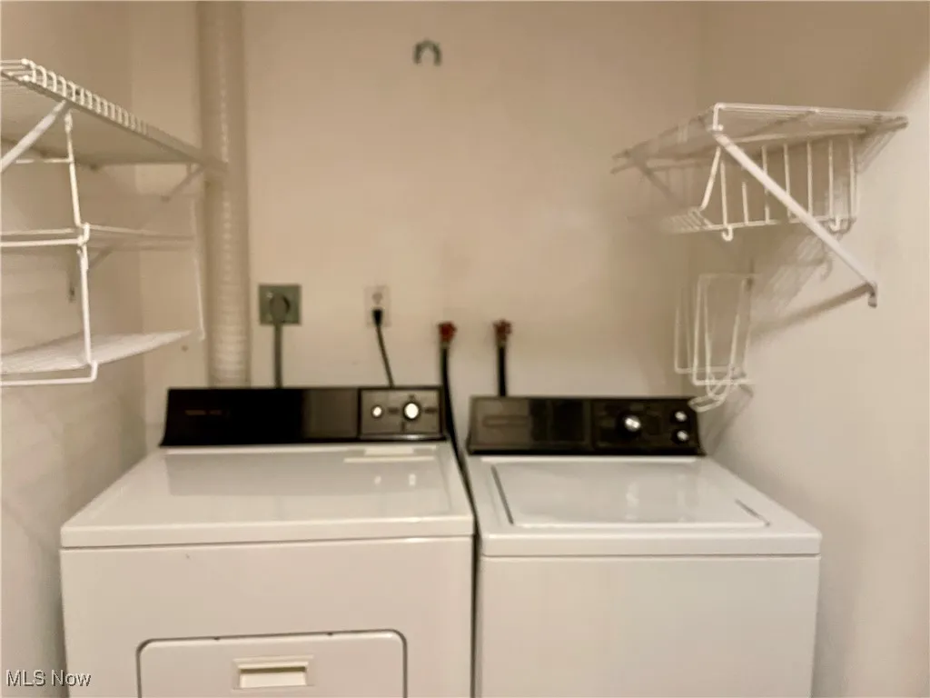 Laundry closet with washer and clothes dryer
