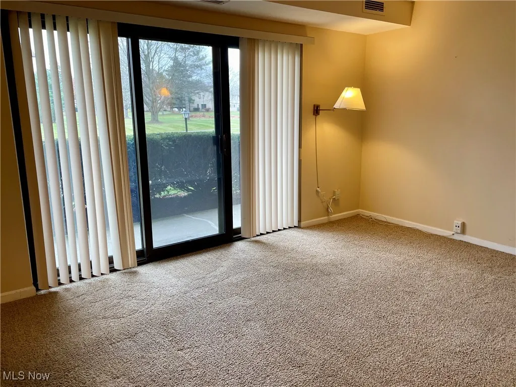 Living room featuring baseboards and carpet flooring