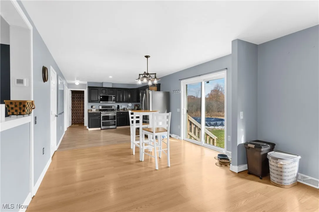 Dining room featuring light wood-style flooring and a chandelier