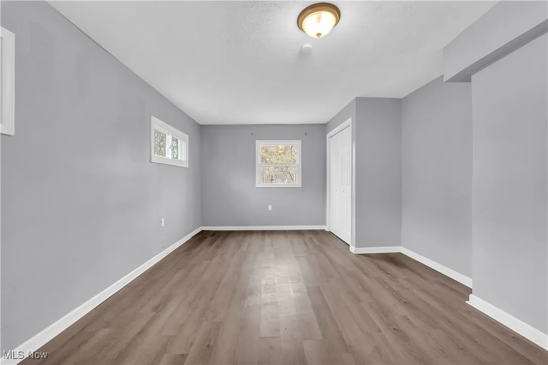 Empty room with baseboards and light wood-style floors