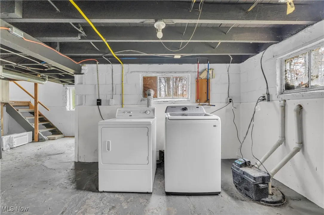 Laundry area with concrete flooring and independent washer and dryer