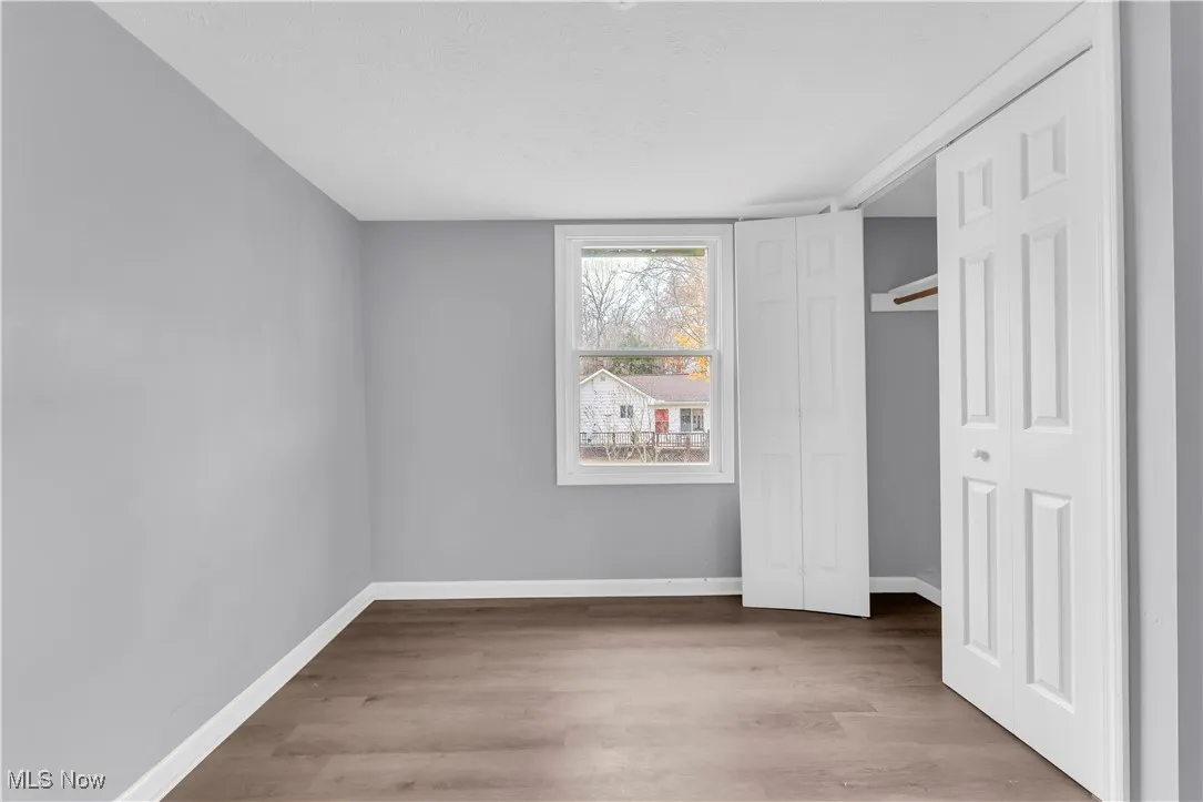 Unfurnished bedroom with a closet and light wood-type flooring