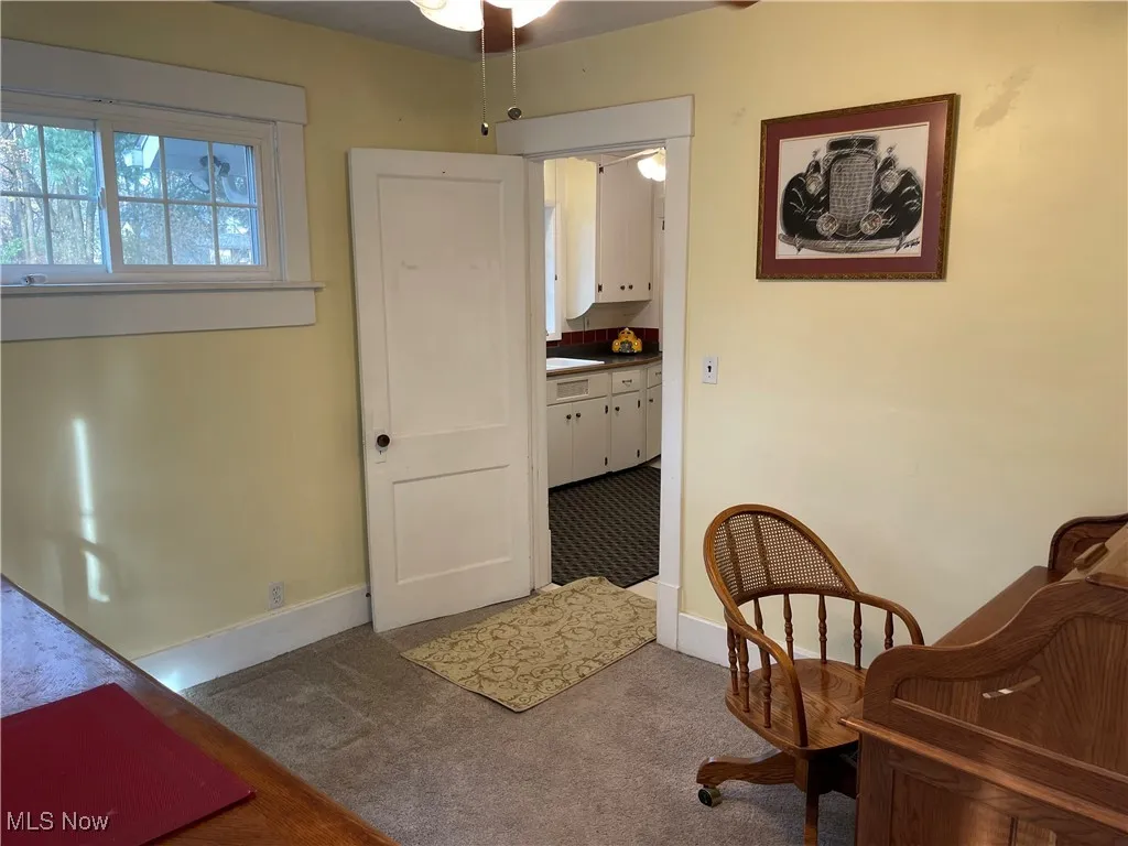 Sitting room featuring carpet and ceiling fan