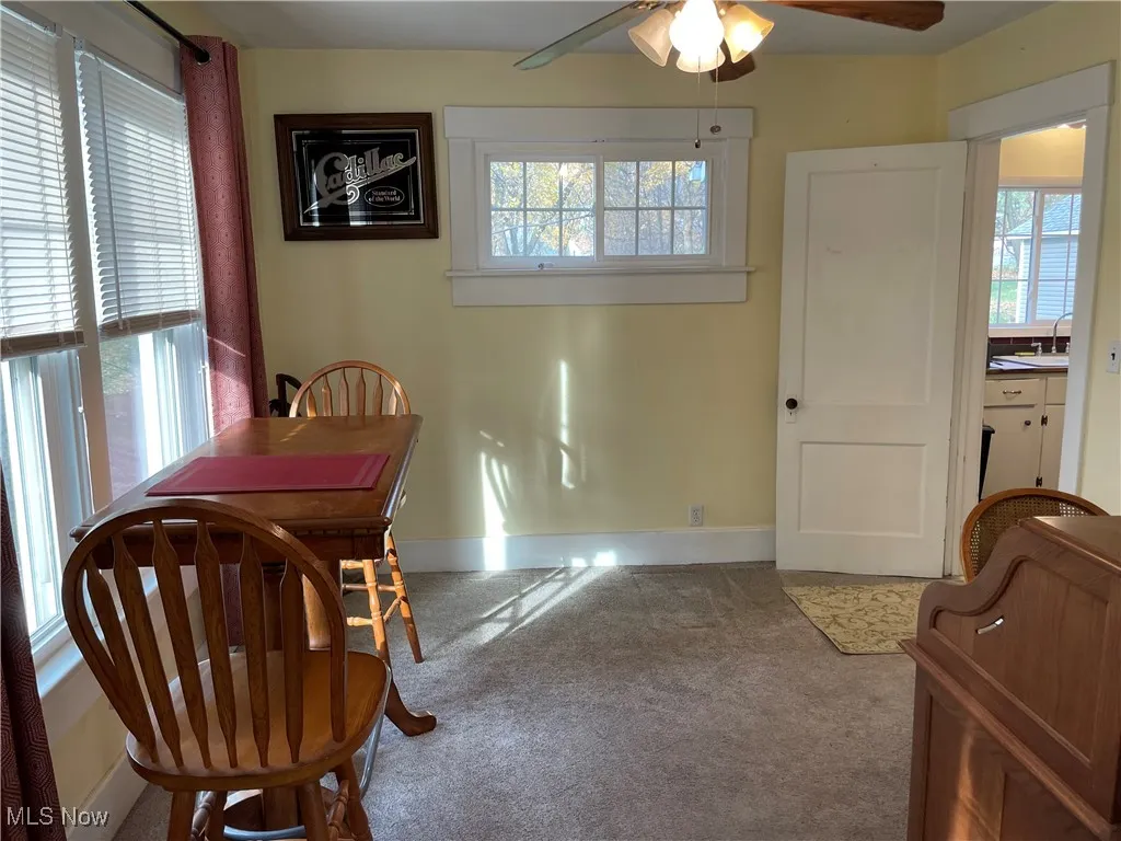 Dining room with ceiling fan and carpet floors