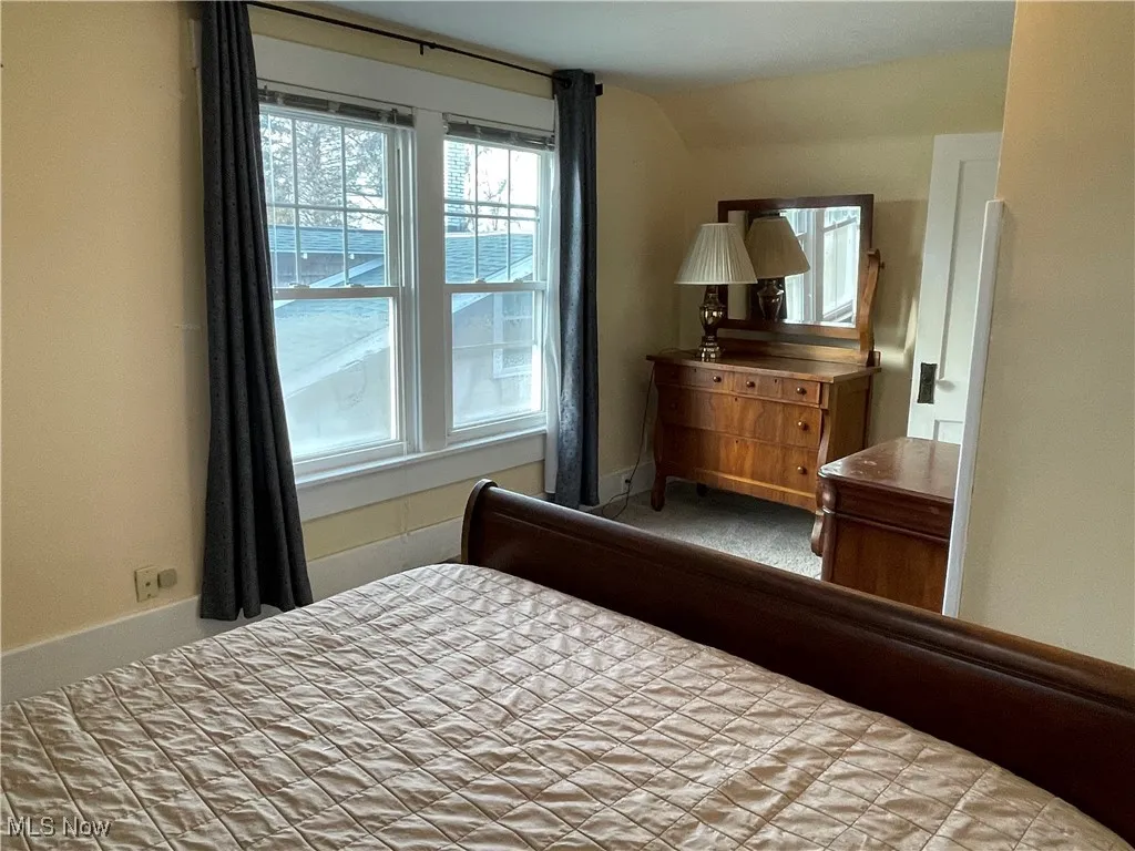 Bedroom with lofted ceiling and carpet flooring