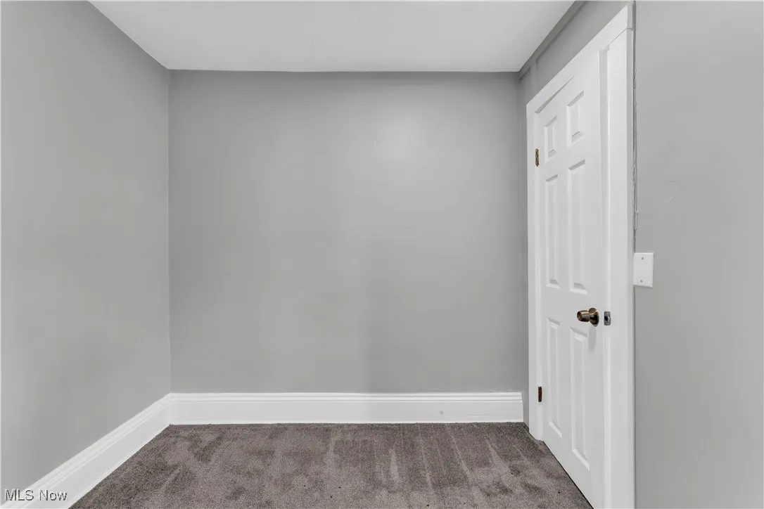 Carpeted spare room with baseboards