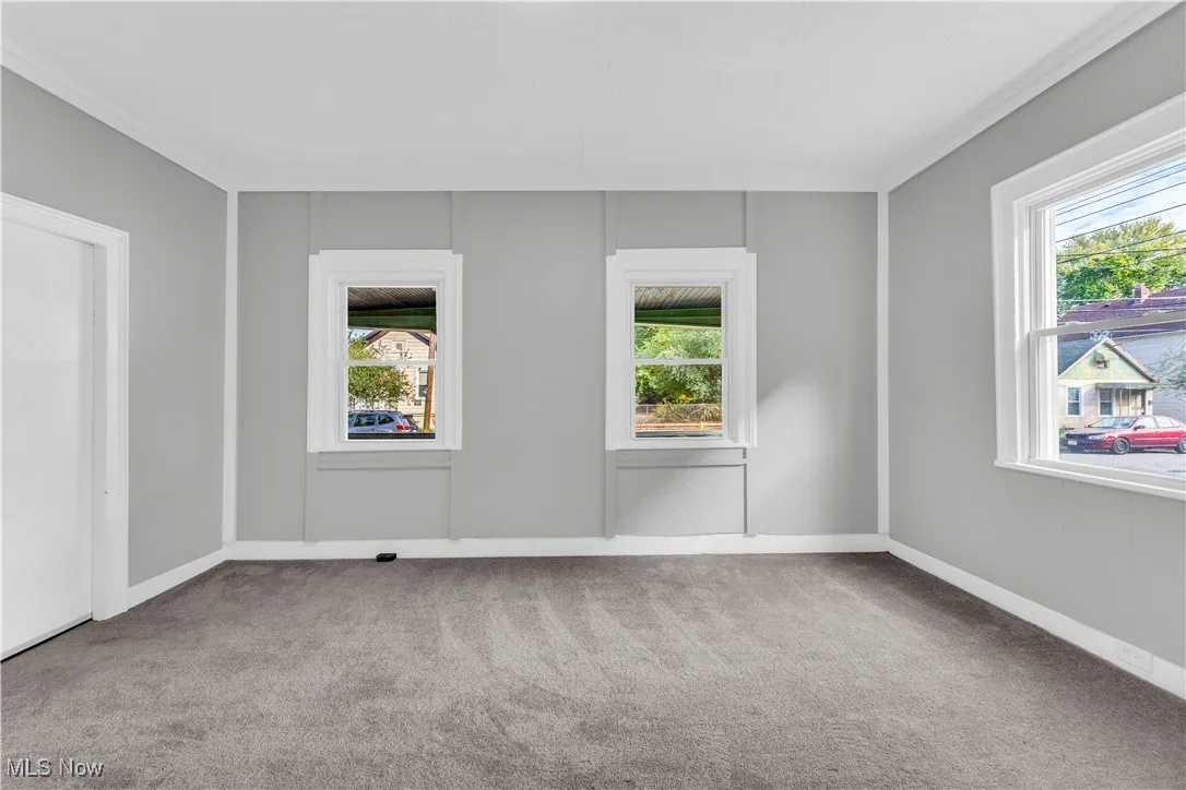 Unfurnished room featuring light colored carpet and ornamental​​‌​​​​‌​​‌‌​‌‌​​​‌‌​‌​‌​‌​​​‌​​ molding