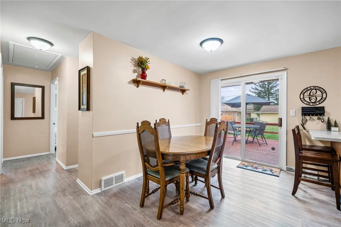 Dining space featuring attic access and light wood-style floors