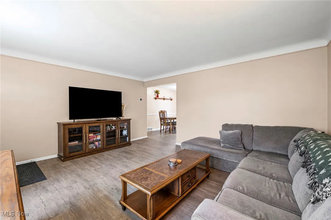 Living room featuring wood finished floors and baseboards