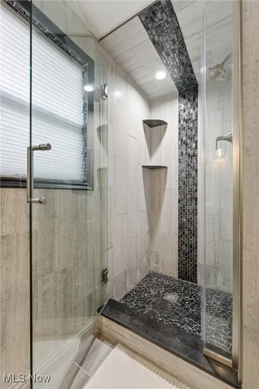 Full bathroom featuring a stall shower