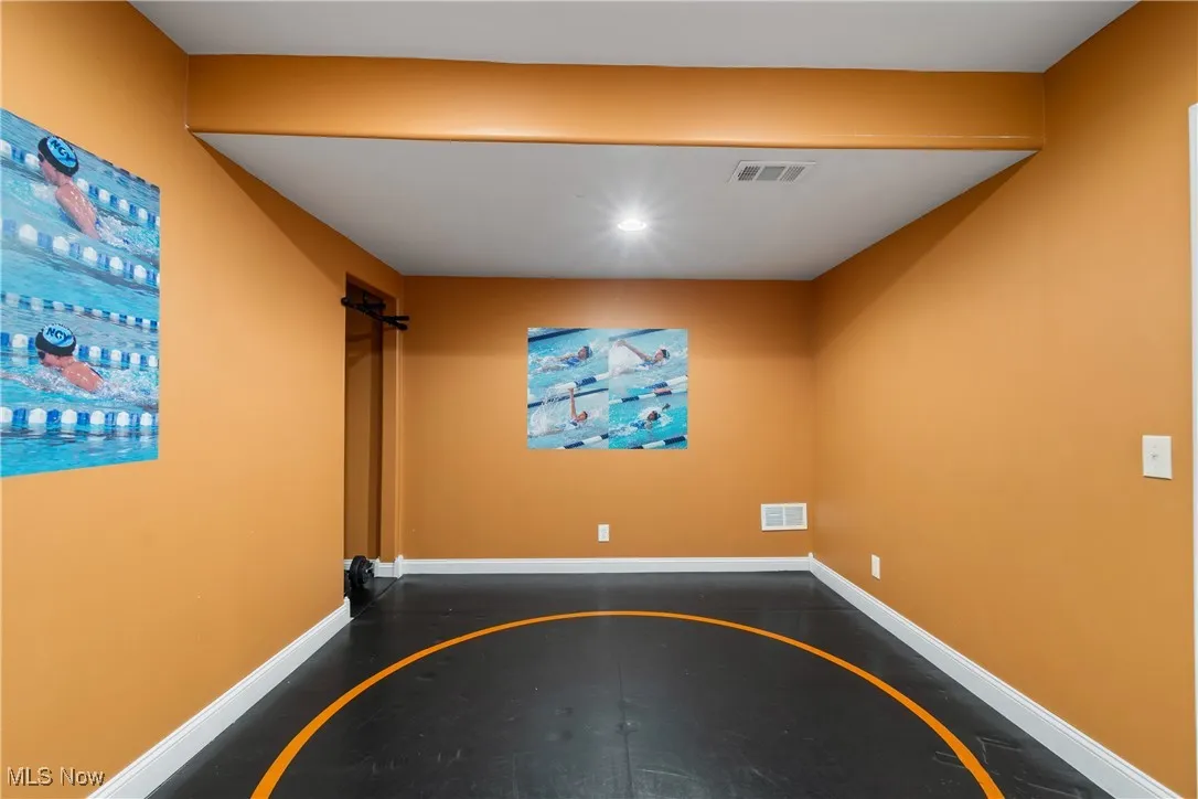 Unfurnished room featuring inlaid floor details and recessed lighting