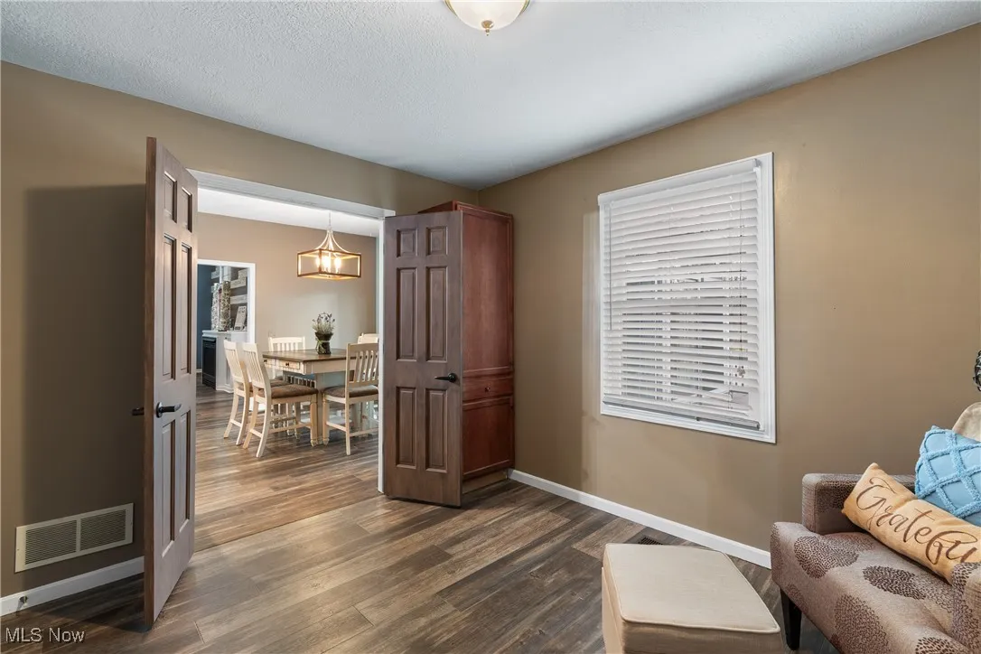 Sitting room with dark wood finished floors and a textured ceiling