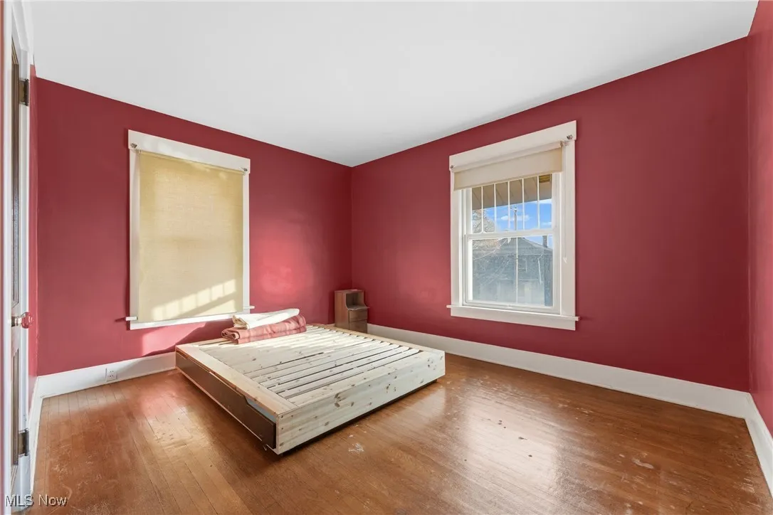 Bedroom featuring baseboards and hardwood / wood-style flooring
