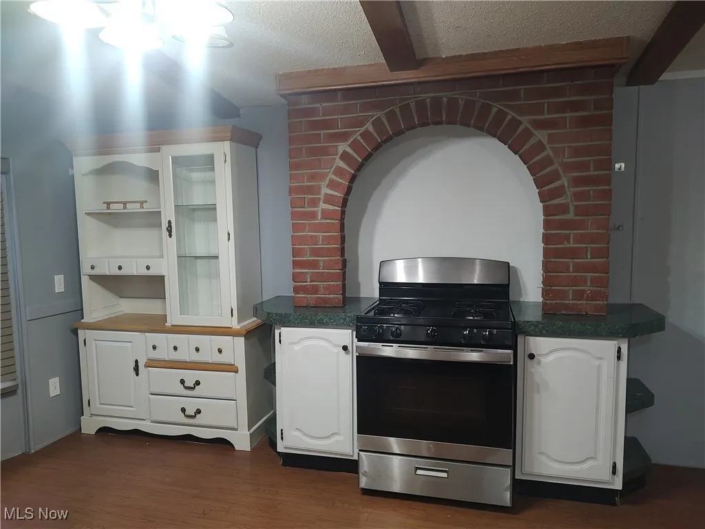 Cooking area complete with counter space and brick arch.