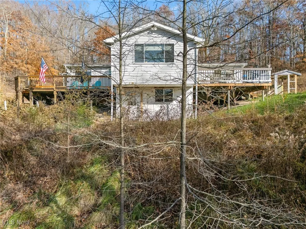 View of side of home featuring a wooden deck