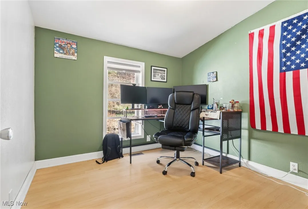 Office space with wood finished floors and baseboards