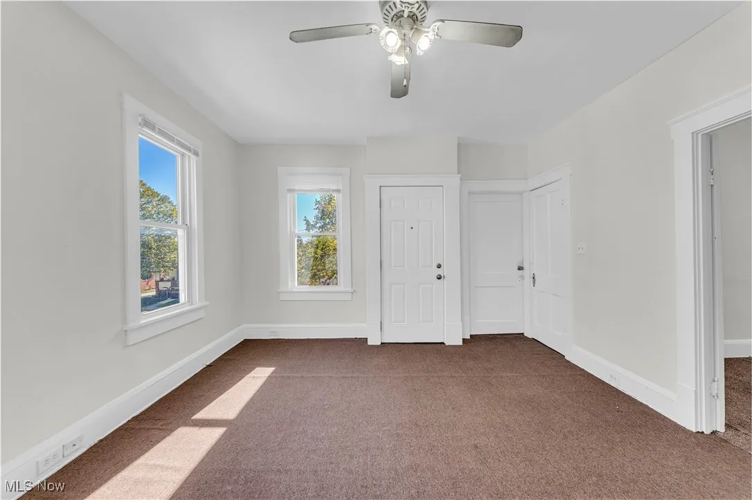 Unfurnished bedroom featuring carpet flooring and ceiling fan