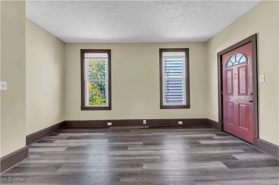 Entryway featuring plenty of natural light, dark wood finished floors, and a textured ceiling