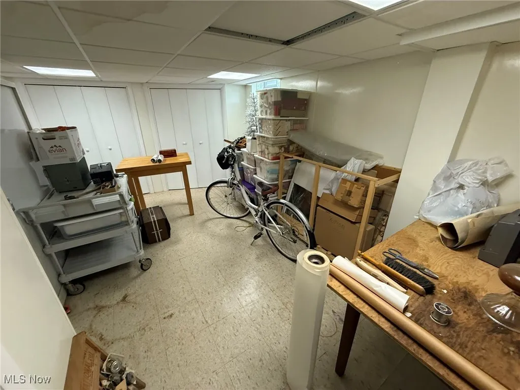 Finished below grade area with light floors and a drop ceiling