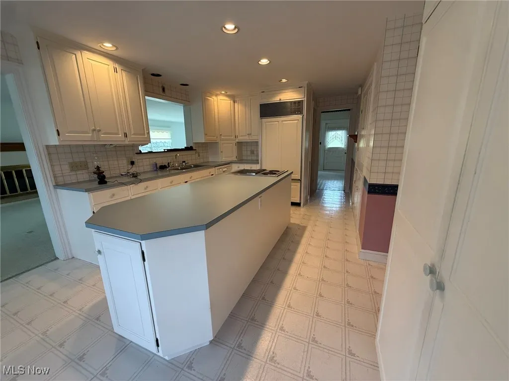 Kitchen featuring light floors, white cabinetry, decorative backsplash, and recessed​​‌​​​​‌​​‌‌​‌‌​​​‌‌​‌​‌​‌​​​‌​​ lighting