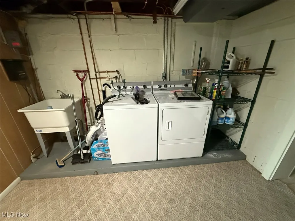 Laundry room with washer and clothes dryer