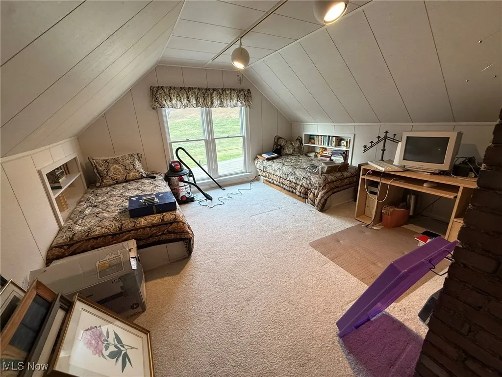 Carpeted bedroom with lofted ceiling