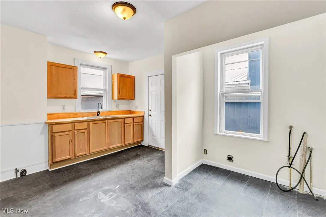 Kitchen featuring baseboards and light countertops