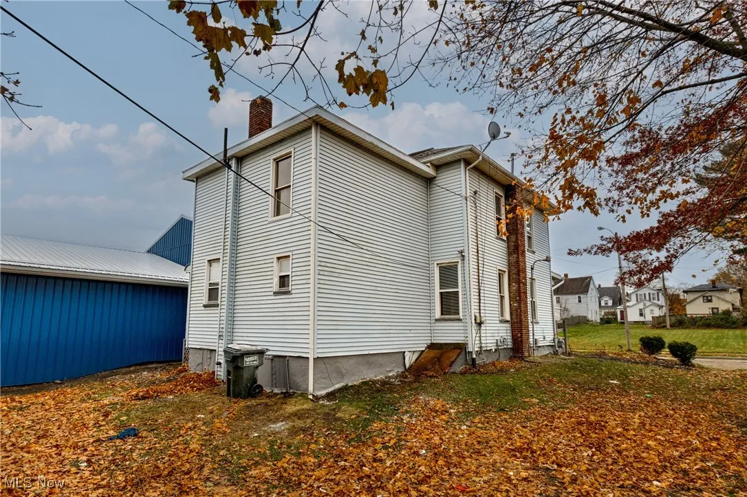 View of side of property with a chimney