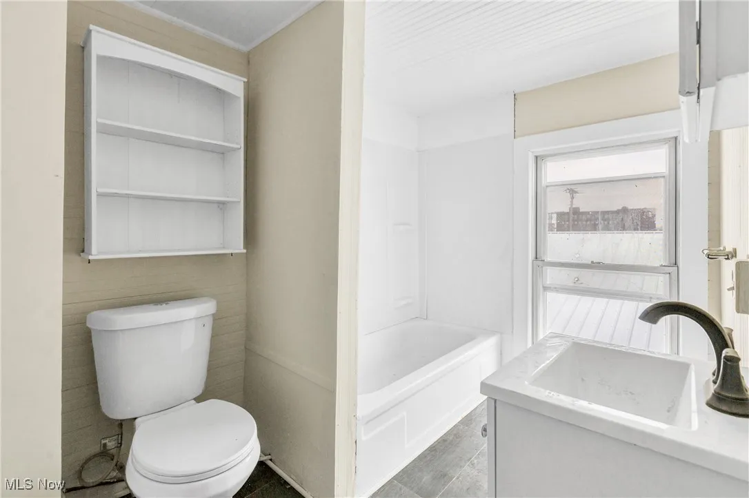 Full bathroom featuring vanity and toilet