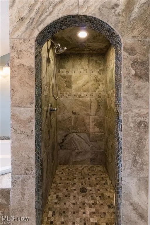 Full bath featuring tiled shower