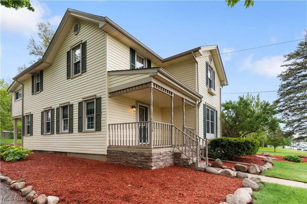 Traditional-style home featuring covered porch