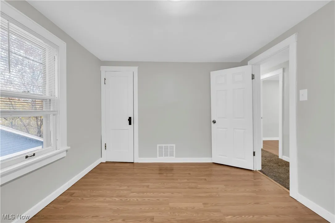 Unfurnished room with baseboards and light wood finished floors