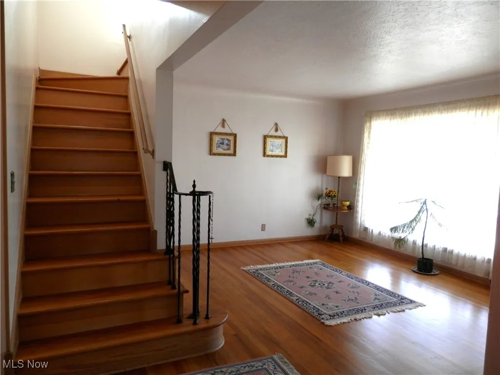 Staircase featuring wood finished floors 
