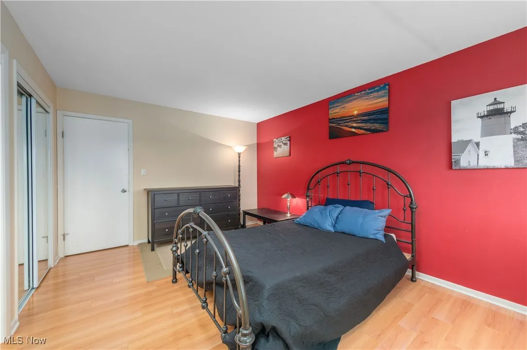 Bedroom with light wood-type flooring and baseboards