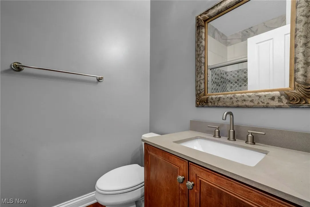 Full bath featuring a shower stall and vanity