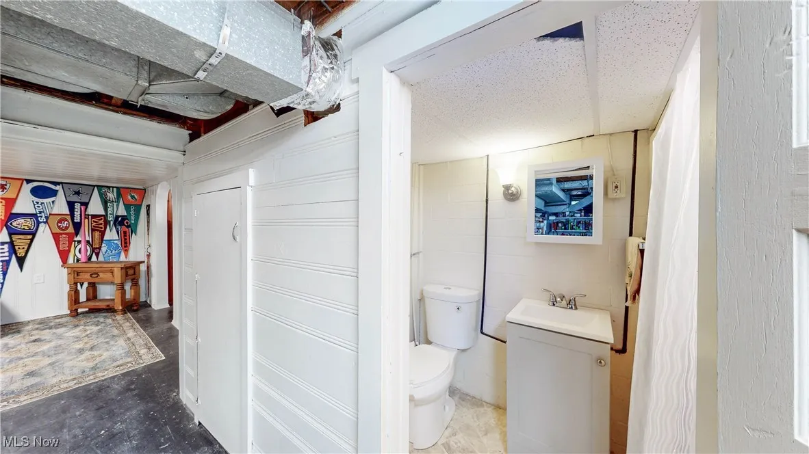 Half bathroom with vanity and toilet