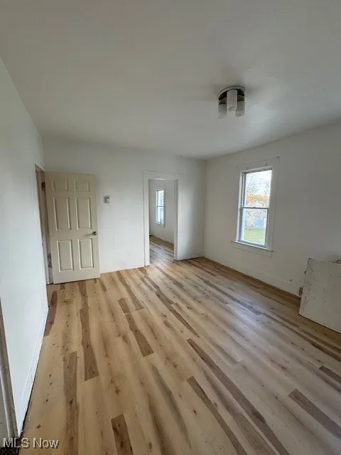 Featuring light wood-style flooring and baseboards