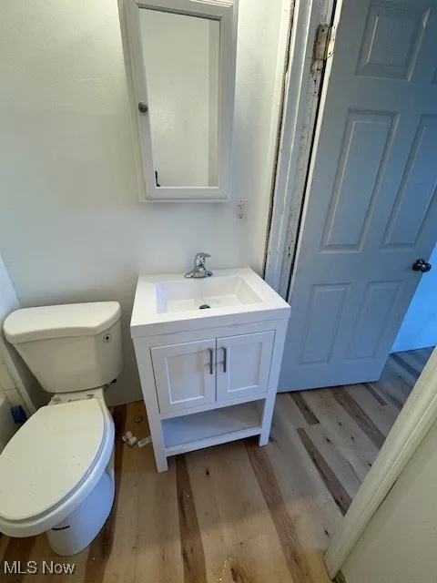 Half bath featuring light wood-type flooring and vanity