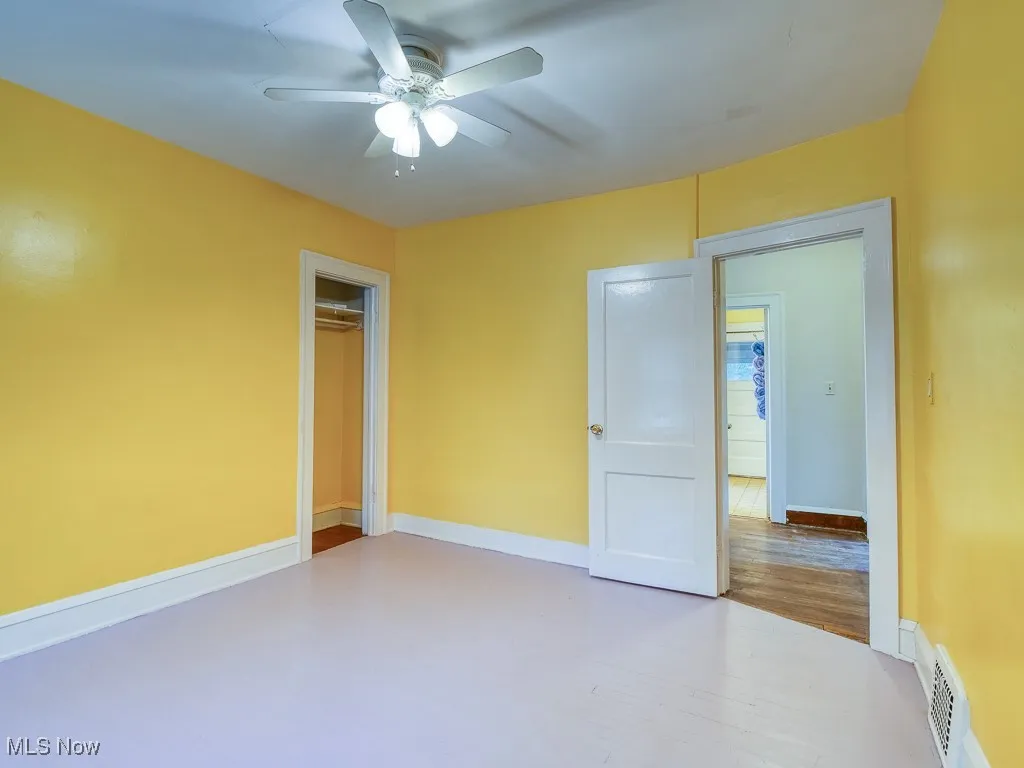 Unfurnished bedroom featuring a closet, a ceiling fan, and wood finished floors